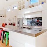 Permen colored bar stools in a white kitchen