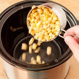 gieten the corn into the slow cooker